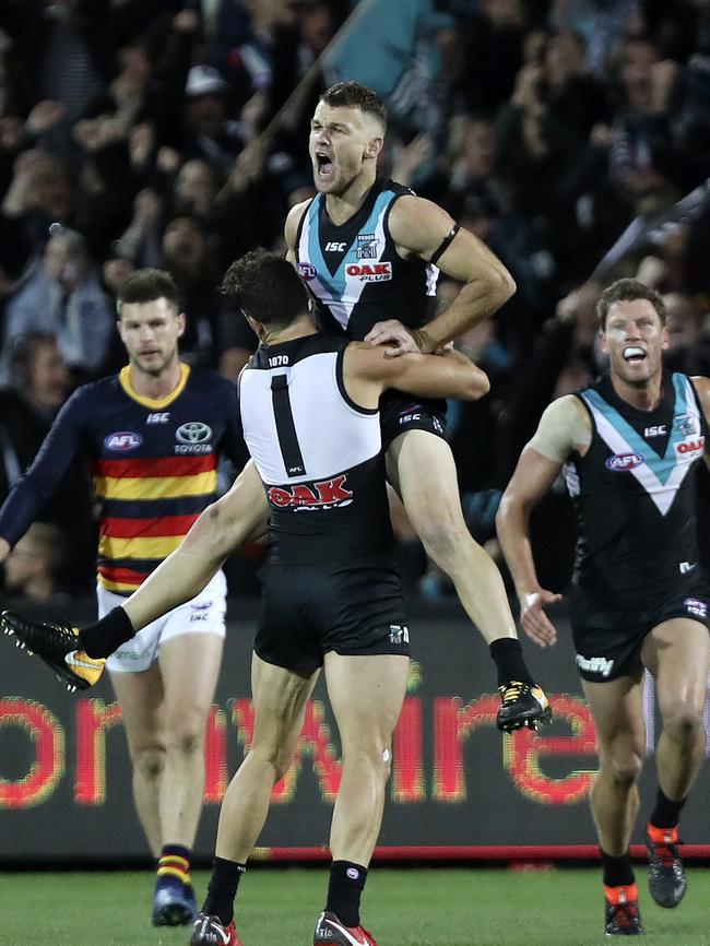 Sam Powell-Pepper hoists Robbie Gray to the sky as he celebrates one of his five third-quarter goals in the Showdown. Picture Sarah Reed