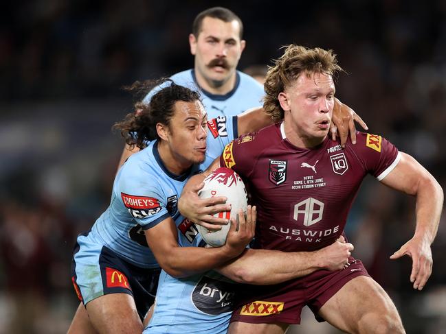 Reuben Cotter of the Maroons is tackled during game one of the 2022 State of Origin series between the New South Wales Blues and the Queensland Maroons at Accor Stadium on June 08, 2022 in Sydney, Australia. (Photo by Cameron Spencer/Getty Images)