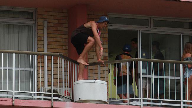 Another Schoolie risks his life on the Gold Coast as he jumps from one balcony to another on the fifth floor of a Surfers Paradise hotel. Picture: Marc Robertson.