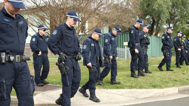 Officers sweep Jones Street for clues today. Picture: Tim Hunter