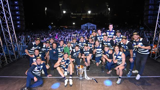 The Cats with the Cup on stage at Yarra Park, with a huge crowd of fans — and the MCG — in the background. Picture: Getty Images