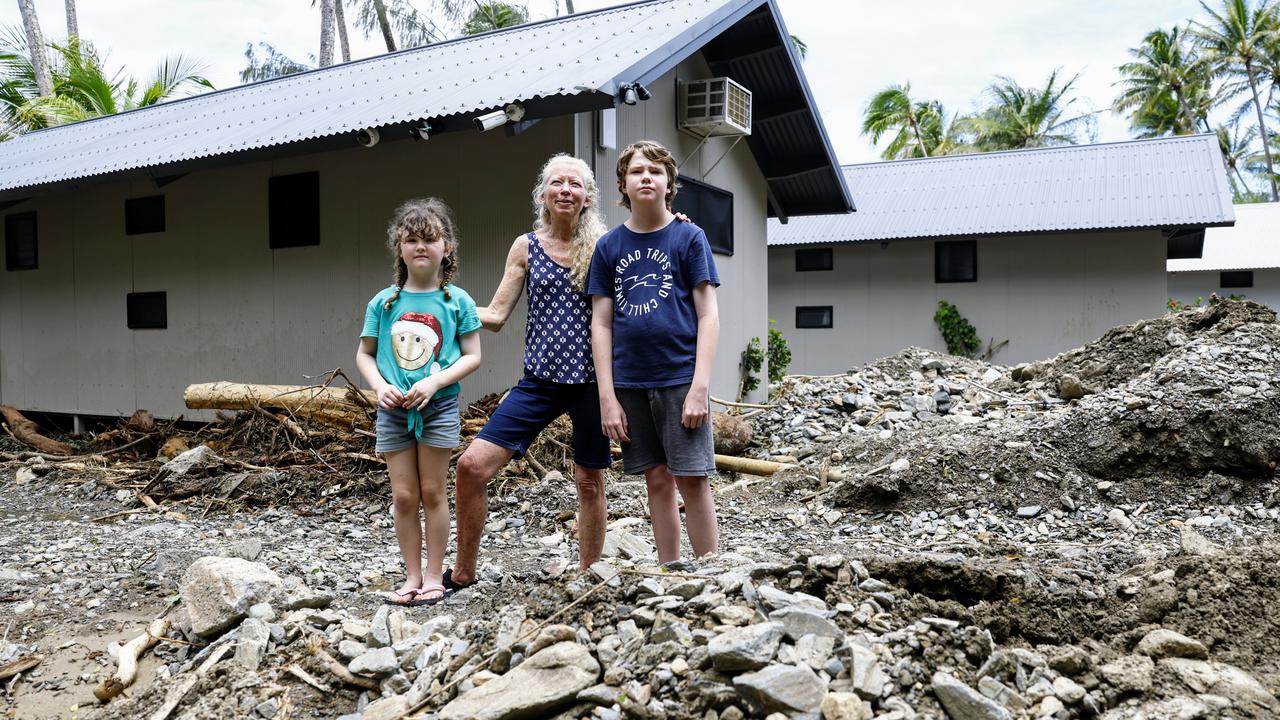 Katrina Weekes stands in the Ellis Beach holiday park with her daughter Riley, 7, and son Athan, 11, where huge landslides tore through the park on Sunday. Picture: Brendan Radke
