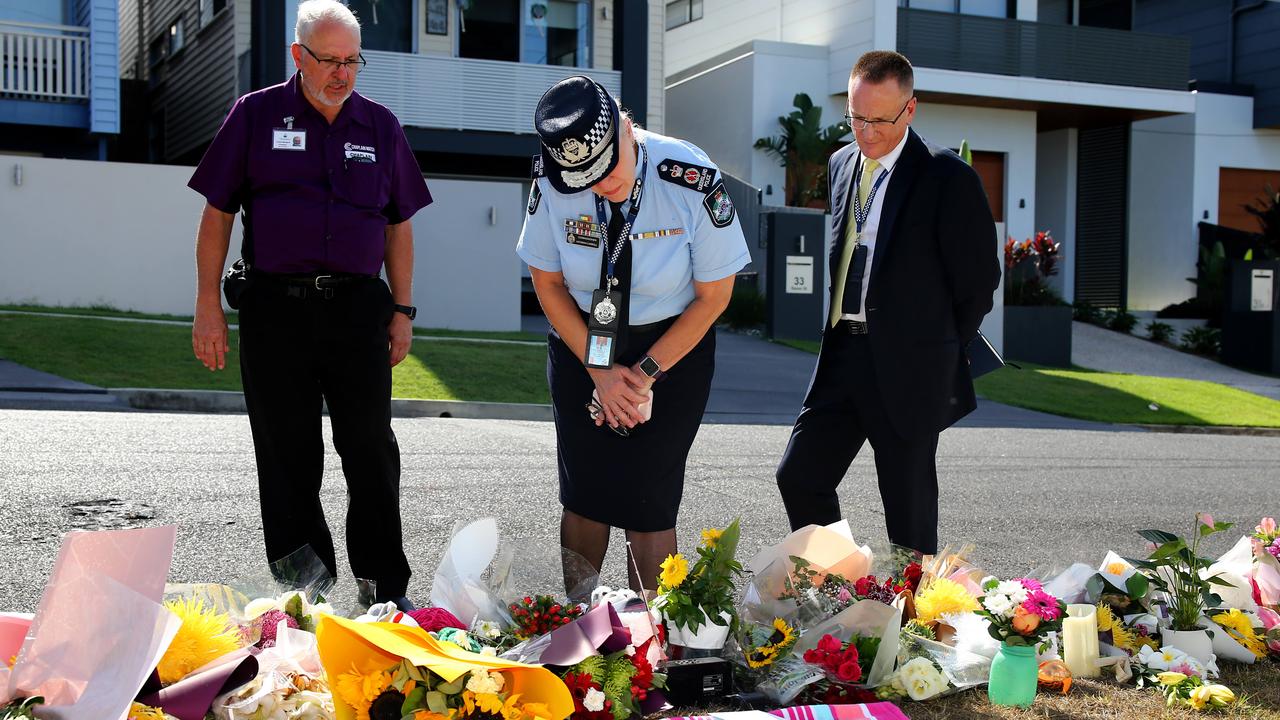 Police Commissioner Katarina Carroll looks at flowers left for Hannah Clarke and her children at Camp Hill. Picture: AAP/David Clark