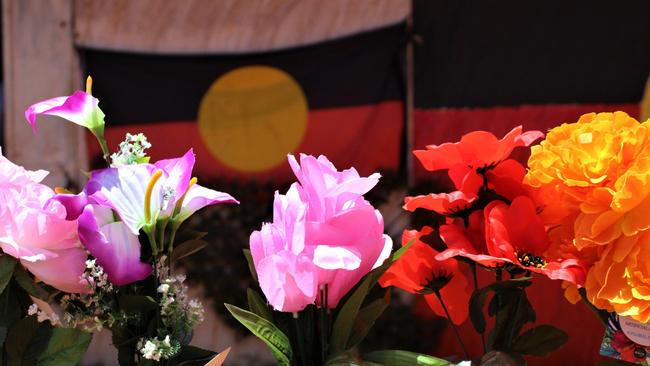 Flowers line the fence outside House 511 in Yuendumu where Kumanjayi Walker was killed. Picture: Jason Walls