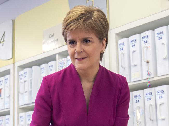 Scotland's First Minister Nicola Sturgeon washes her hands before meeting staff supporting Scotland's public information response to the new coronavirus, COVID-19, during a visit to the NHS 24 contact centre at the Golden Jubilee National Hospital in Glasgow, Scotland, on March 4, 2020. - Up to one fifth of employees could be off work in Britain when the coronavirus outbreak peaks, the government said Tuesday outlining a new action plan. Britain had 51 confirmed cases of COVID-19 as of 9:00 am (0900 GMT), an increase of 12 in 24 hours, as Prime Minister Boris Johnson warned the count was "highly likely" to keep rising. (Photo by Jane Barlow / POOL / AFP)