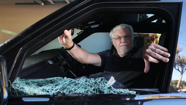 David with his Range Rover which was badly damaged by youths wielding axes who it is believed were targeting the log books of high end vehicles. Picture: Glenn Hampson.