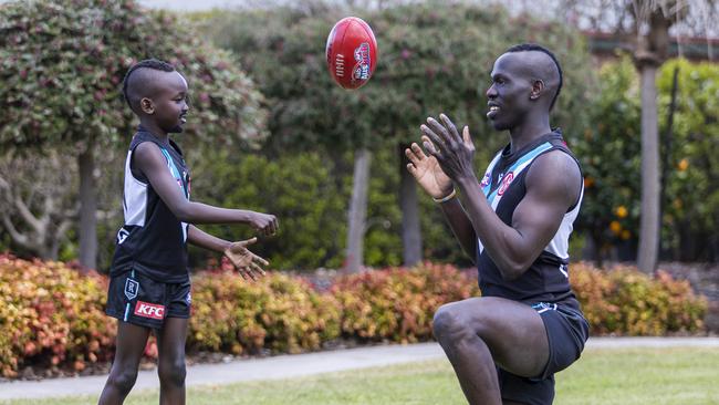 Aliir Aliir and Timothy Kuol trade some handballs. Picture: Aaron Francis