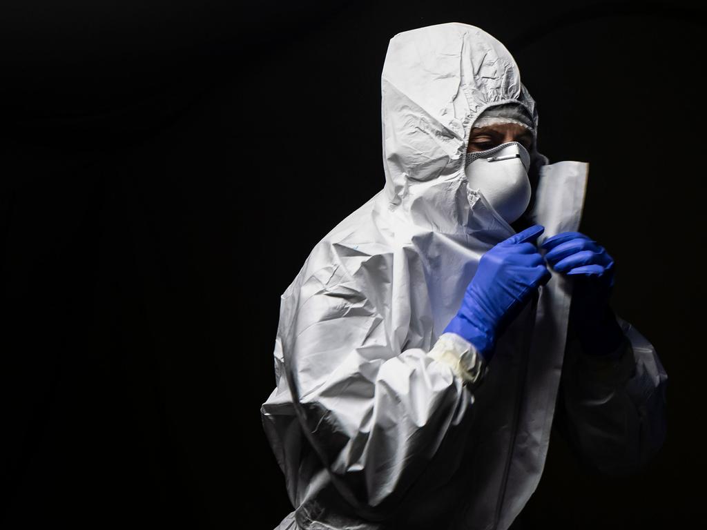 A military medical worker adjusts her protection suit on January 12 at a drive-in testing centre for COVID-19 set up by the Italian Army on the parking lot of the Juventus stadium in Turin. Picture: Marco Bertorello / AFP