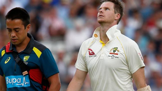 Steve Smith is taken from the field after being struck in the head. Picture: Ian Kington/AFP