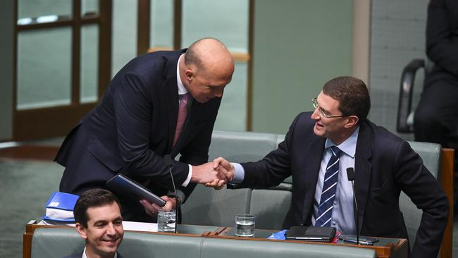 Peter Dutton is welcomed by Julian Leeser in question time in 2018.