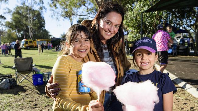 Amy Doomadgee with daughters Dixie (left) and Isabella Doomadgee enjoy fairy floss at Sadie's Day Out, a special community event to celebrate the life of five-year-old crash victim Sadie, held at Cambooya State School, Saturday, June 7, 2025. Picture: Kevin Farmer