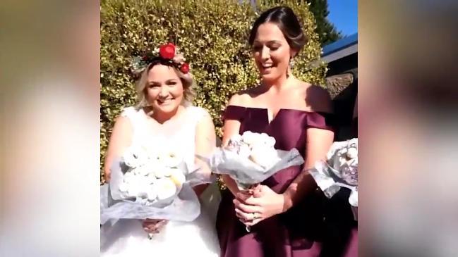 Bride walks down the aisle with a bouquet of doughnuts