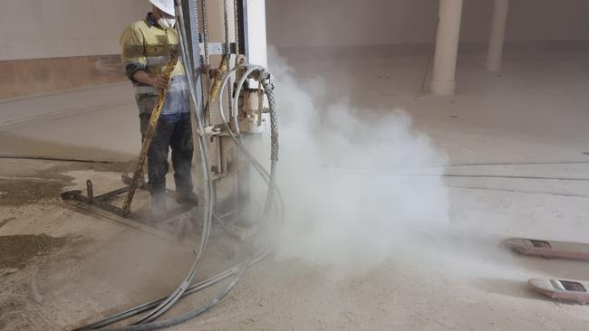 A contractor drills into the reservoir’s slab to allow concrete grout to be pressure injected into the subterranean cavities. Picture: Supplied