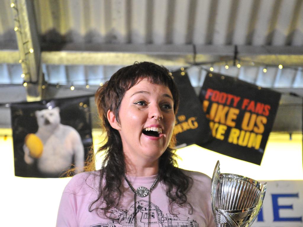 Michelle "Darlzy" Gearin celebrates winning the best mullet competition during Mulletfest, a special event designed to celebrate the hairstyle that's all about business at the front, party at the back, at Chelmsford Hotel in Kurri Kurri, NSW. (AAP Image/Perry Duffin) 