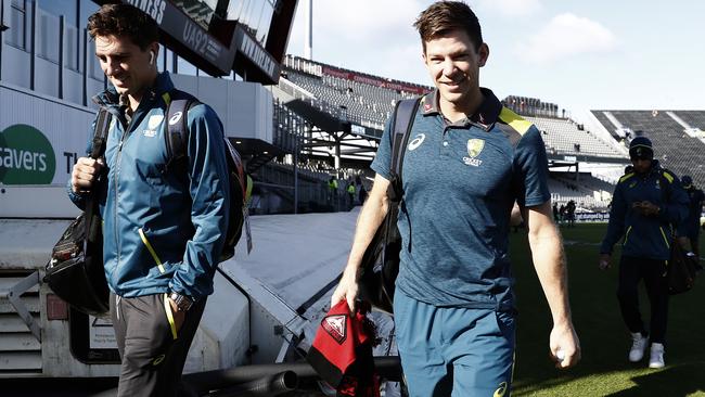 Pat Cummins and Tim Paine, carrying a Bombers scarf, arrive at the ground today. Picture: Getty