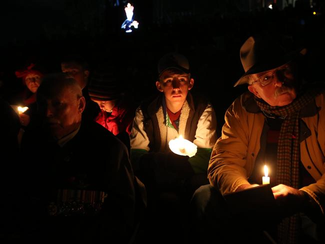 Attendees at the Canberra dawn service listened silently as excerpts from soldiers diaries were read aloud. Picture: Kym Smith