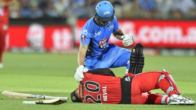 The Strikers’ Jono Dean checks on Nevill after the accident. (AAP Image/David Mariuz)