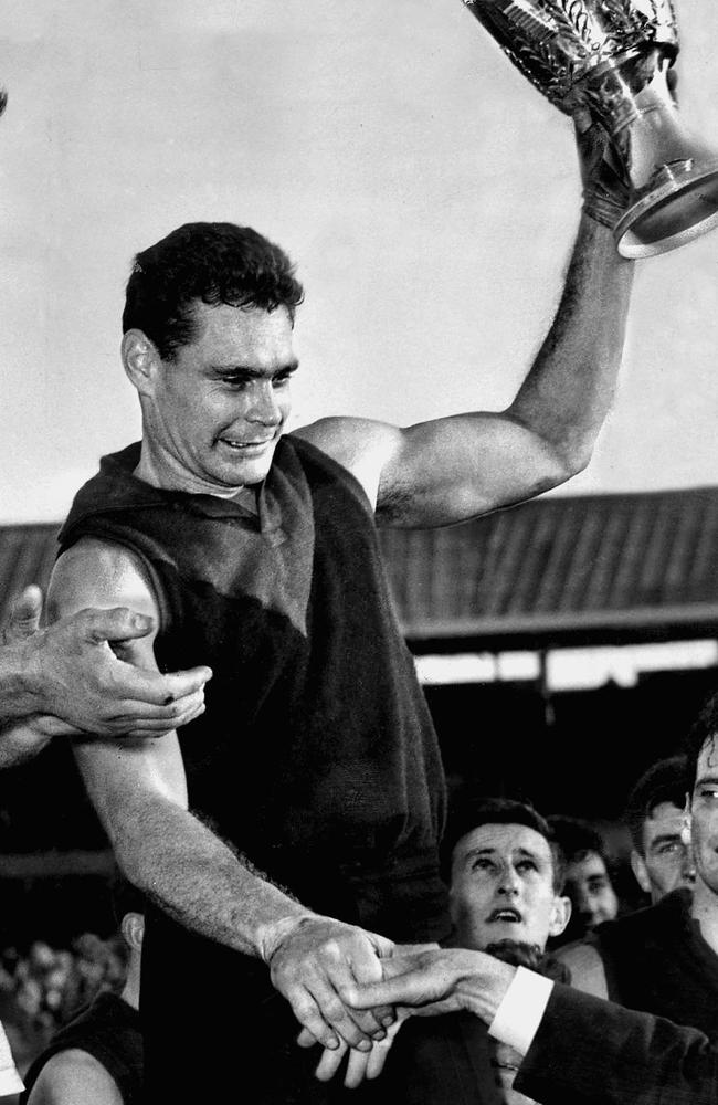 Ron Barassi holds up the premiership cup after winning the 1964 Grand Final with Melbourne, over Collingwood.