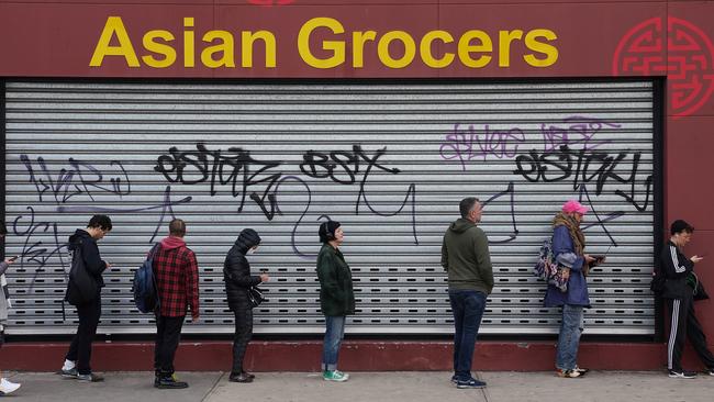 People queue outside a Centrelink office in Melbourne’s Preston. Picture: AAP