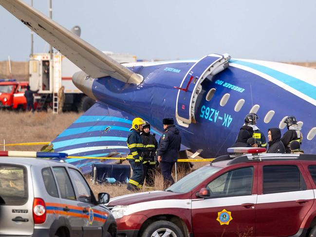 Emergency specialists work at the crash site of an Azerbaijan Airlines passenger jet near the western Kazakh city of Aktau on December 25, 2024. (Photo by Issa Tazhenbayev / AFP)