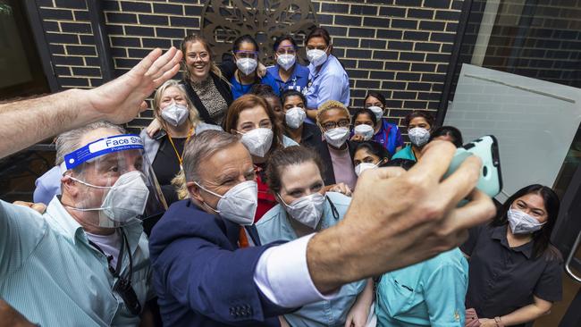 Anthony Albanese and Minister for Aged Care Anika Wells pose for a selfie with staff during a visit to St Paul's Terrace Residential Aged Care. Picture: Getty Images