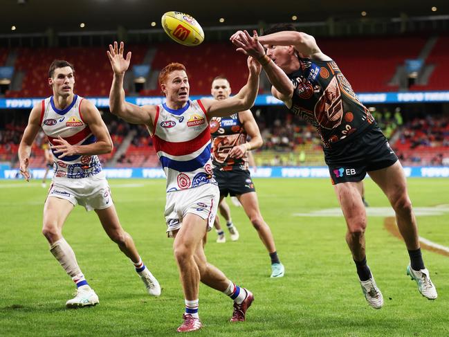 Giants defender Sam Taylor handballs under pressure from Ed Richards. Picture: Matt King/AFL Photos