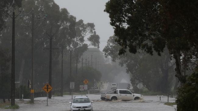 30/09/16 - Flooding of the North Para River in the Barossa Valley. A car remains stranded at Lights Pass in the Barossa Valley, as someone else decides it's probably not a good idea to attempt a crossing. Picture Dean Martin