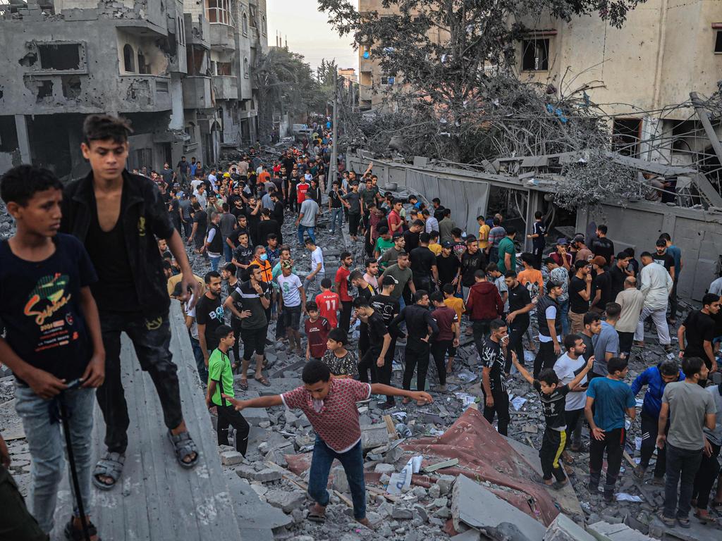 People gather in a neighbourhood in Rafah in the southern Gaza Strip, after it was hit by an Israeli strike. Picture: AFP