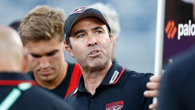 GEELONG, AUSTRALIA - MARCH 01: Brad Scott, Senior Coach of the Bombers addresses his players during the 2024 AFL AAMI Community Series match between the Geelong Cats and Essendon Bombers at GMHBA Stadium on March 01, 2024 in Geelong, Australia. (Photo by Michael Willson/AFL Photos via Getty Images)