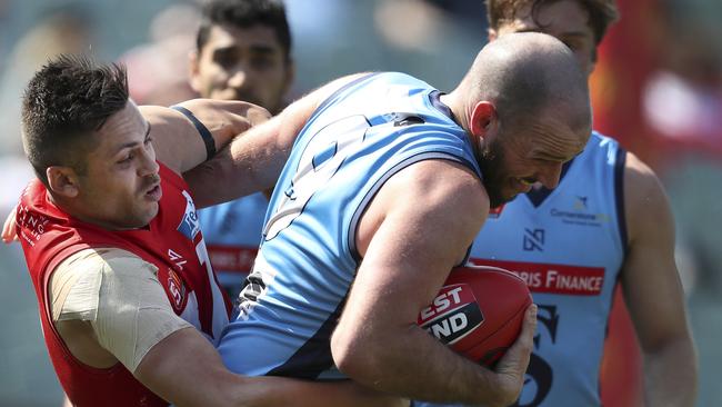 North’s Robbie Young tackles Sturt’s Zane Kirkwood on Sunday. Picture: Sarah Reed