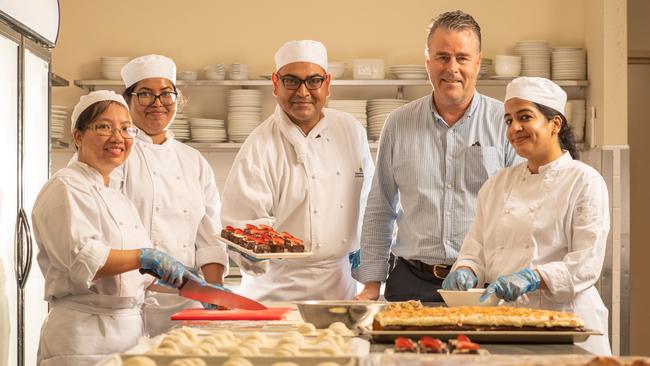 International College of Advanced Education chief executive Sean Mahoney, second from right, with chef Emon Shaikh, centre, and hospitality students Thi Phuong Nguyen, Thanya Ranasinghe and Payal Soni. Picture: Che Chorley