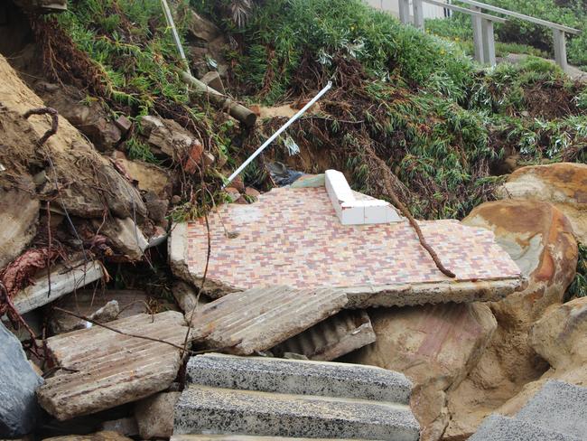 Two homes have partially collapsed during high tides and rough seas at Wamberal Beach.