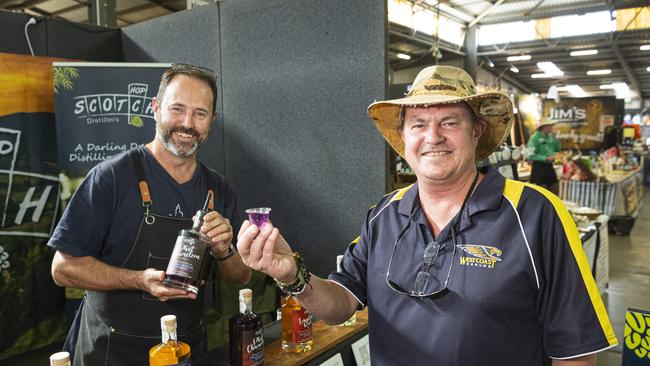 Brad Smith (right) tastes a colour changing gin called Phat Chameleon from Matt Service of Gowrie based Hop Scotch Distillers at the Toowoomba Royal Show, Thursday, April 18, 2024. Picture: Kevin Farmer