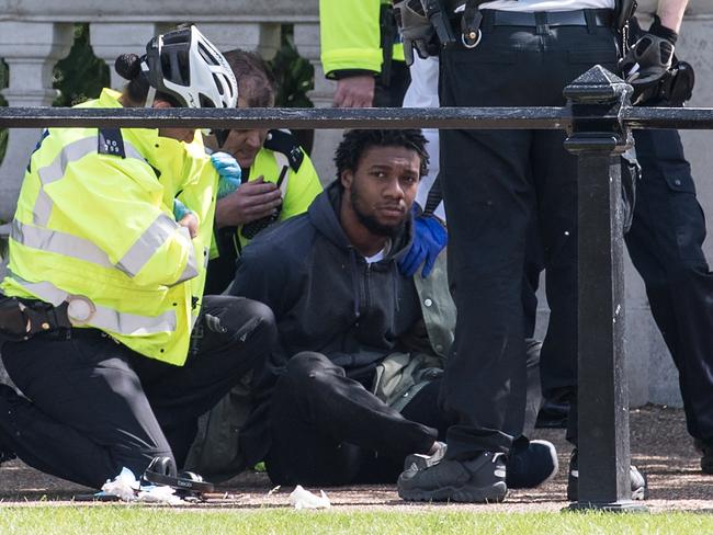 A man is detained by police near Buckingham Palace. Picture: Carl Court / Getty