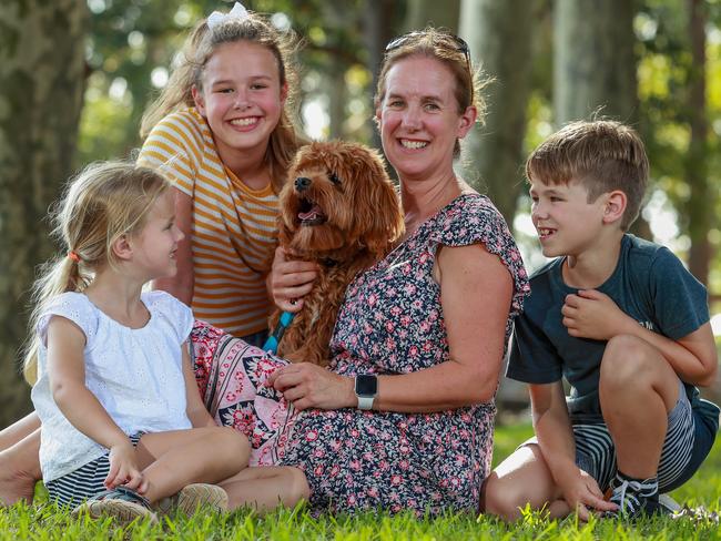 Felicity Hughes with her children and her 8 month-old Cavoodle, Arlo. Picture: Justin Lloyd