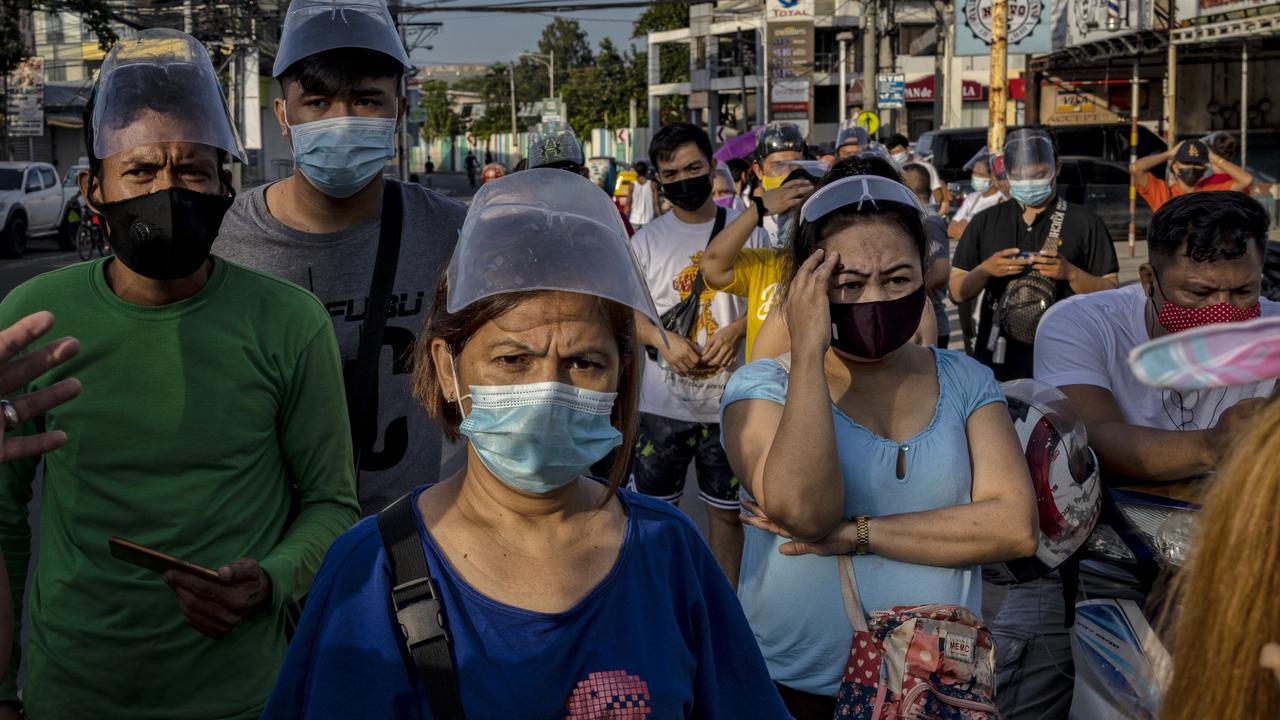 As a strict lockdown is reimposed in the Philippines to curb the Delta spread, thousands are defying curfew and going to vaccination sites as early as midnight in the hopes of getting vaccinated. Picture: Ezra Acayan/Getty Images