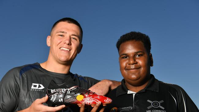 North Queensland Cowboys player Scott Drinkwater with Cowboys House student Elson Asai, 13, from Yorke Island in the Torres Strait with the painted boot. Picture: Evan Morgan