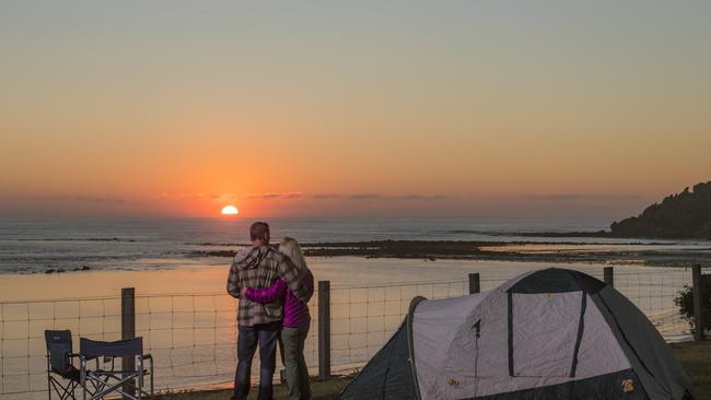 Couple Glen Ryan and Lauren Harsley enjoy sunrise from a caravan site at Barwon Heads Caravan Park. Picture: Jason Edwards