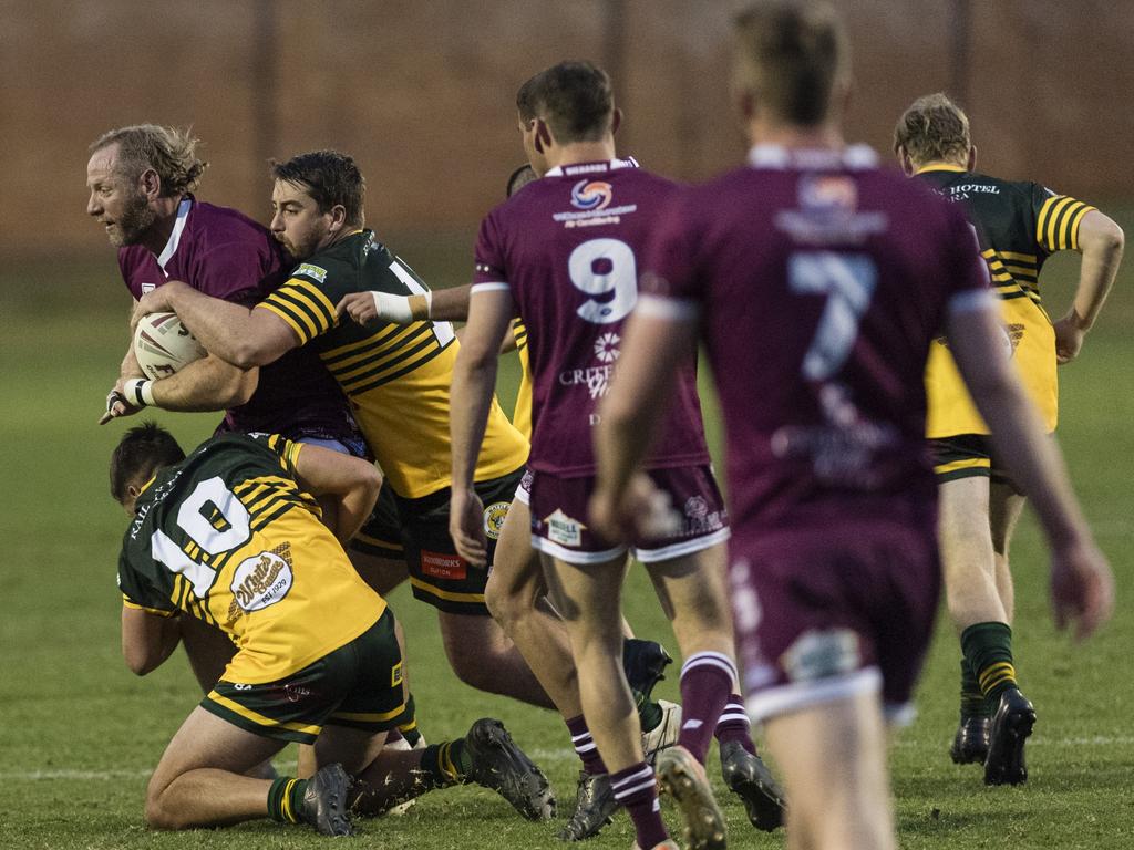 Broc Turner of Dalby is tackled by Timothy Duggan and Garth Lonergan of Wattles. Picture: Kevin Farmer.