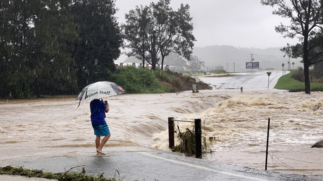 The causeway at Maudsland Drive, Oxenford, on the Gold Coast was blocked to all traffic due to rising floodwaters which damaged fences and the road surface. Picture: NCA NewsWire / Scott Powick