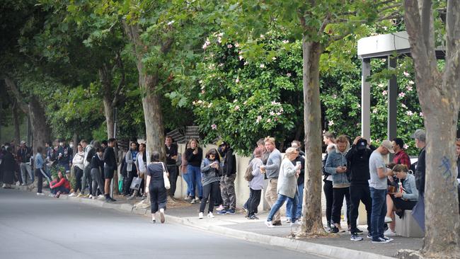 A large queue of people waits to enter a Centrelink office in Prahran. Picture: Andrew Henshaw