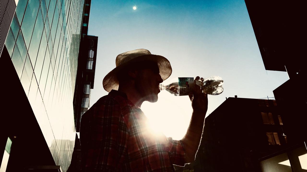 Man hydrating himself in the city. Picture: Roy VanDerVegt/AAP