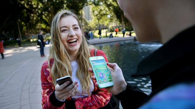 Tamra Foy and Finn Melville playing Pokemon Go at Hyde Park, which is one of many hotspots for the game around Sydney. Picture: Richard Dobson