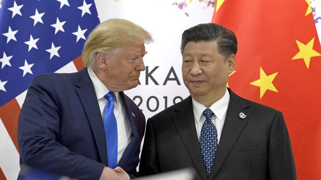 FILE - In this  June 29, 2019, file photo, U.S. President Donald Trump, left, shakes hands with Chinese President Xi Jinping during a meeting on the sidelines of the G-20 summit in Osaka, western Japan. Facing another U.S. tariff hike, Xi is getting tougher with Washington instead of backing down. Both sides have incentives to settle a trade war that is battering exporters on either side of the Pacific and threatening to tip the global economy into recession. (AP Photo/Susan Walsh, File)