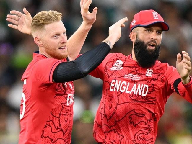 England's Ben Stokes (L) celebrates with England's Moeen Ali after the dismissal of Pakistan's Iftikhar Ahmed during the ICC men's Twenty20 World Cup 2022 final cricket match England and Pakistan at The Melbourne Cricket Ground (MCG) in Melbourne on November 13, 2022. (Photo by WILLIAM WEST / AFP) / -- IMAGE RESTRICTED TO EDITORIAL USE - STRICTLY NO COMMERCIAL USE --