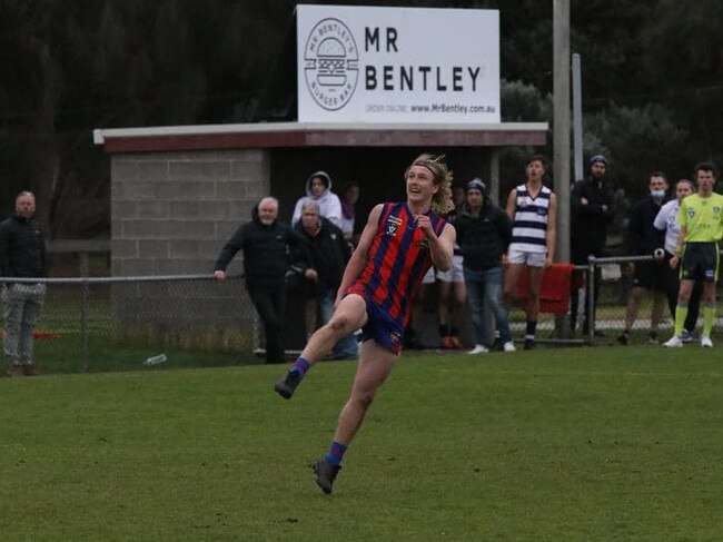 Tommy Hughes kicks the match-winning goal. Picture: Rye FNC