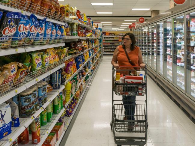 ONE TIME WEB USE FOR NEWS.COM.AU ONLY - FEES APPLY - MUST DOWNLOAD ON OWN ACCOUNT - 2CA1C8T Woman shopping, walking down an aisle of a Target supermarket in Chicago, America.