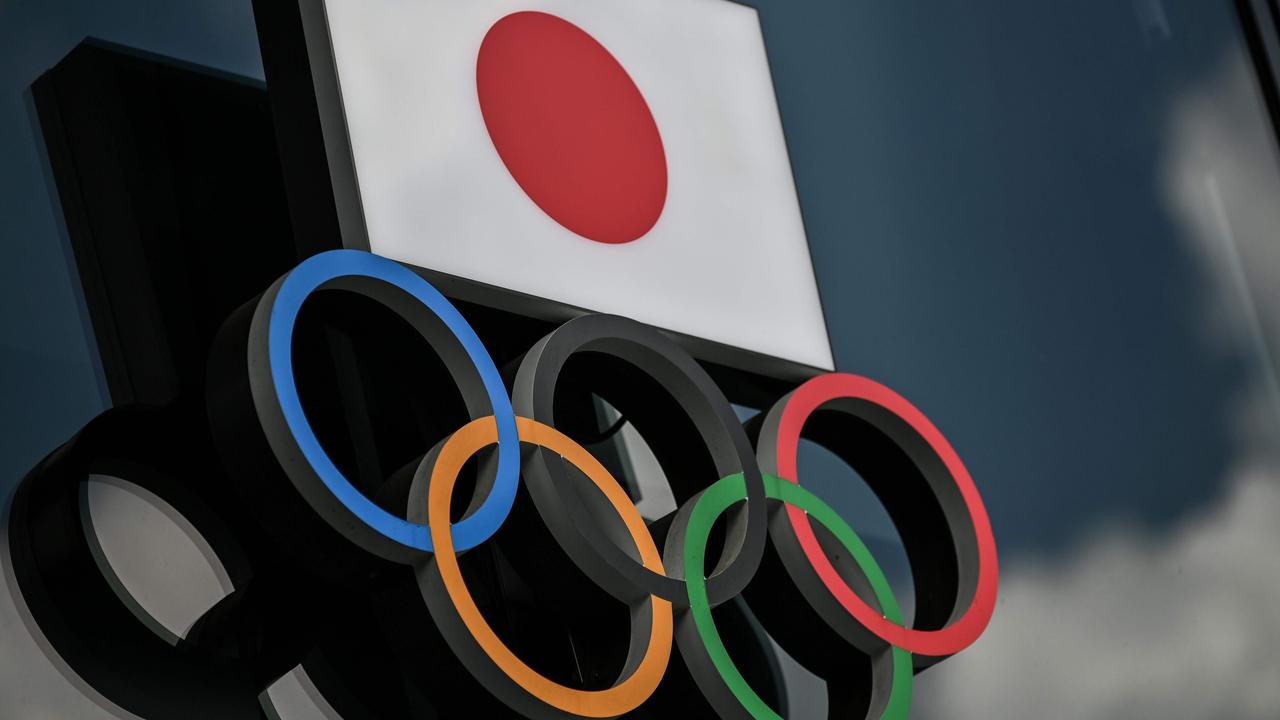 Olympic Rings and the Japanese flag are seen outside the Olympic Museum in Tokyo.