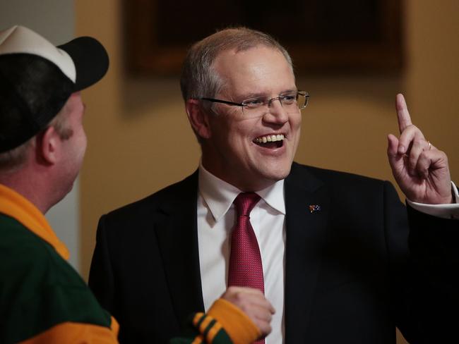 Treasurer Scott Morrison talks to comedian Peter Helliar in the Budget lockup at Parliament House. Picture: Stefan Postles/Getty Images