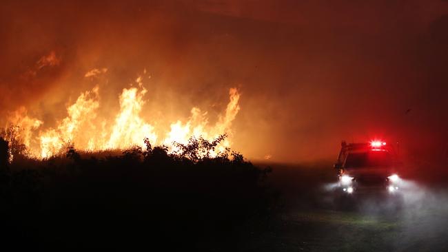 Firefighters on the scene of a bushfire that threatened homes along Palm Meadows Drive and the Boonaroo Park area. Picture: Glenn Hampson.